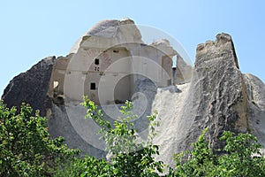 Pigeon lofts carved into the fairy chimneys against a bright blue sky- Cappadocia photo